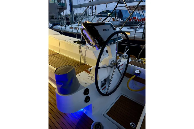 Slide: The Image of Steering wheel of 2021 Beneteau Oceanis 55.1 yacht with illuminated deck. - 27