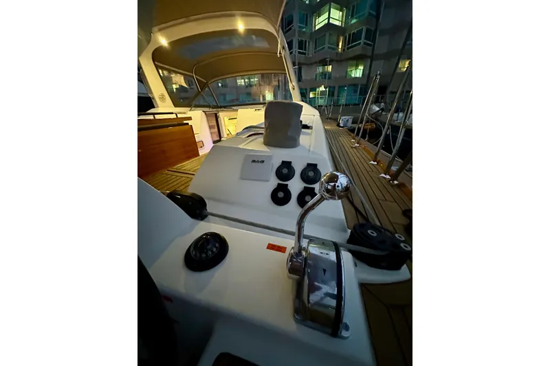 Slide: The Image of Cockpit view of 2021 Beneteau Oceanis 55.1 yacht at dusk, showcasing controls and deck. - 29