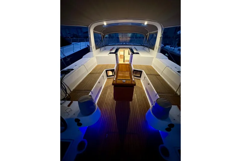 Slide: The Image of 2021 Beneteau Oceanis 55.1 yacht interior with elegant wood and ambient lighting. - 31