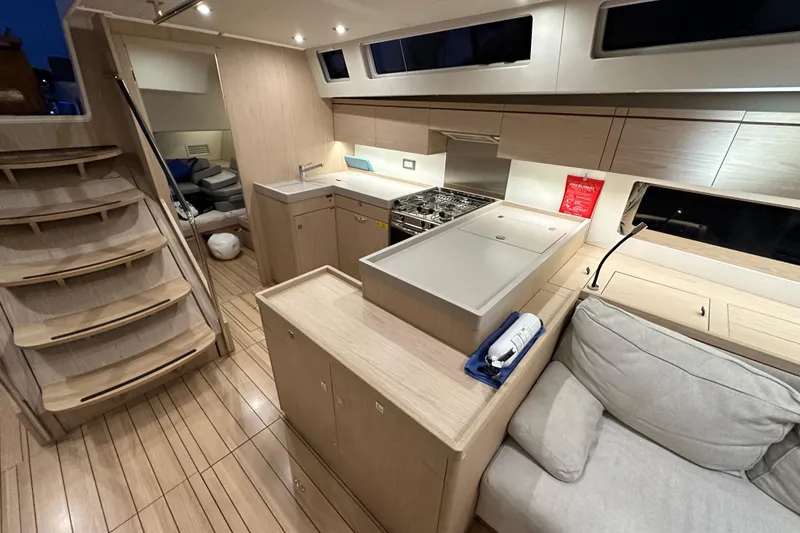 Slide: The Image of Luxurious interior of 2021 Beneteau Oceanis 55.1 yacht with modern kitchen and seating area. - 38