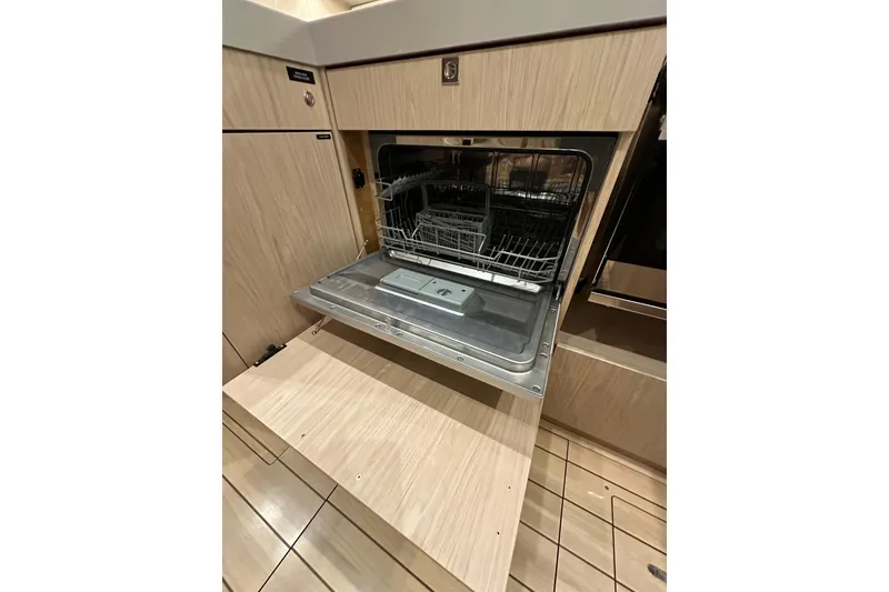 Slide: The Image of Built-in dishwasher on Beneteau Oceanis 55.1 yacht, 2021 model, with open door. - 40