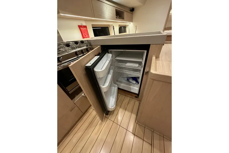 Slide: The Image of Modern kitchen interior of 2021 Beneteau Oceanis 55.1 yacht with open fridge. - 41