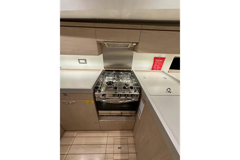 Slide: The Image of Modern kitchen in 2021 Beneteau Oceanis 55.1 yacht with stove and sleek cabinetry. - 44