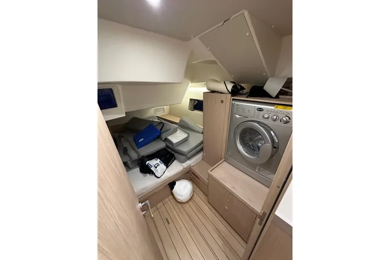Slide: The Image of Interior of 2021 Beneteau Oceanis 55.1 yacht with washing machine and storage area. - 47