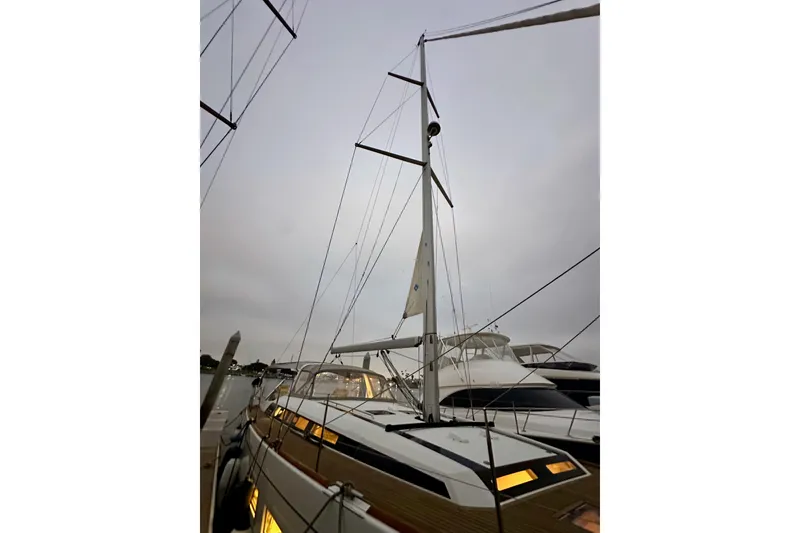 Slide: The Image of 2021 Beneteau Oceanis 55.1 sailboat docked, showcasing mast and sleek design. - 5