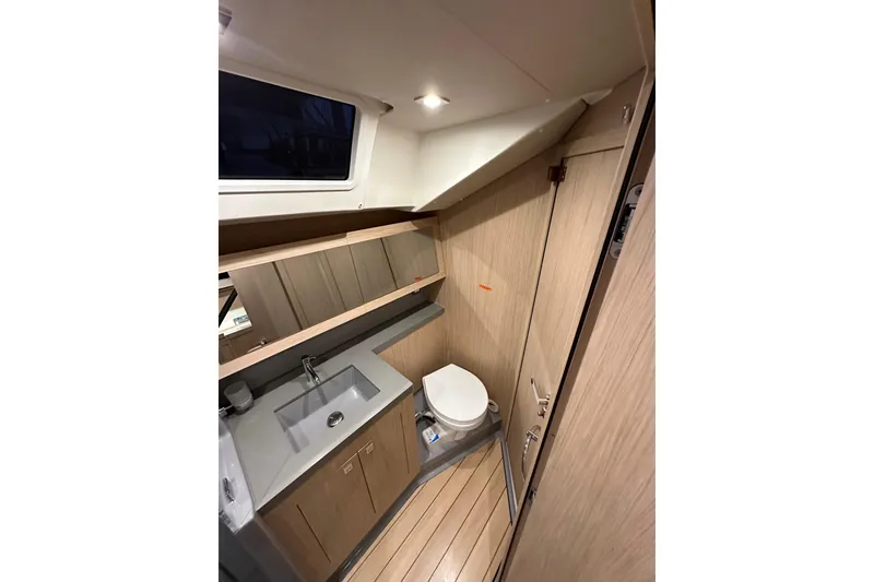 Slide: The Image of Interior of 2021 Beneteau Oceanis 55.1 yacht bathroom with modern fixtures and wood finish. - 50