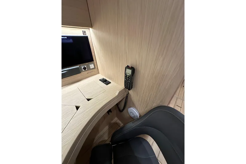 Slide: The Image of Interior of 2021 Beneteau Oceanis 55.1 yacht with navigation equipment and seating. - 60