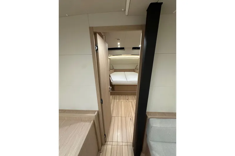 Slide: The Image of Interior of 2021 Beneteau Oceanis 55.1 yacht, featuring modern wood finish and cozy cabin. - 66