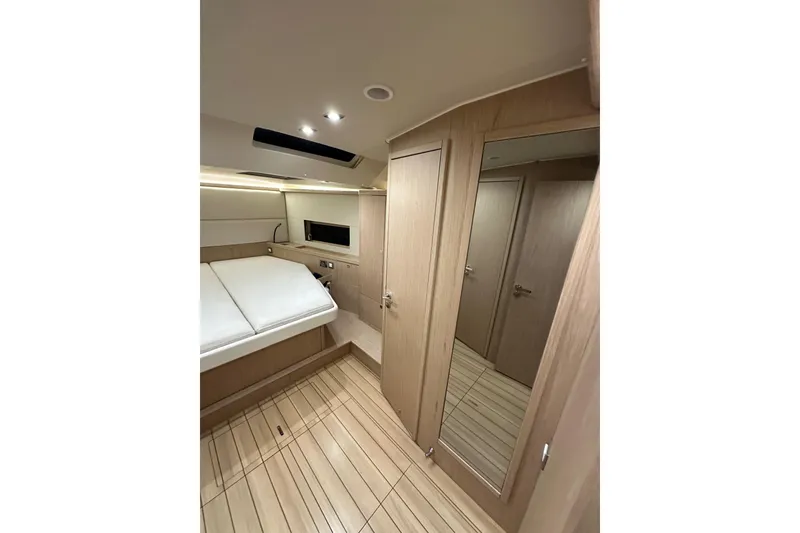 Slide: The Image of Luxurious interior of 2021 Beneteau Oceanis 55.1 yacht cabin with modern wood finish. - 69