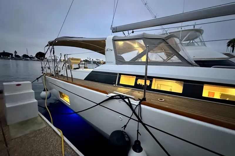 Slide: The Image of 2021 Beneteau Oceanis 55.1 yacht docked at marina during evening. - 7