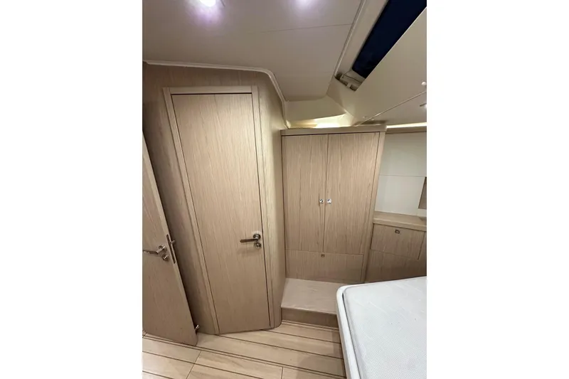 Slide: The Image of Interior of 2021 Beneteau Oceanis 55.1 yacht, featuring wooden cabinetry and modern design. - 73