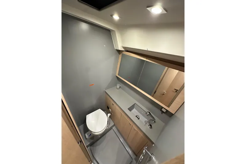 Slide: The Image of Modern bathroom in 2021 Beneteau Oceanis 55.1 yacht with sleek fixtures and ample lighting. - 74