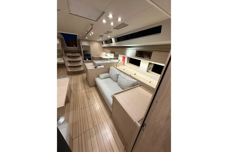 Slide: The Image of Luxurious interior of 2021 Beneteau Oceanis 55.1 yacht with modern furnishings and wooden flooring. - 76