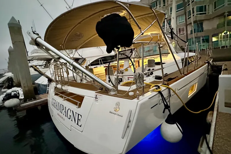 Slide: The Image of 2021 Beneteau Oceanis 55.1 yacht docked, illuminated at night, with "Champagne" name visible. - 8