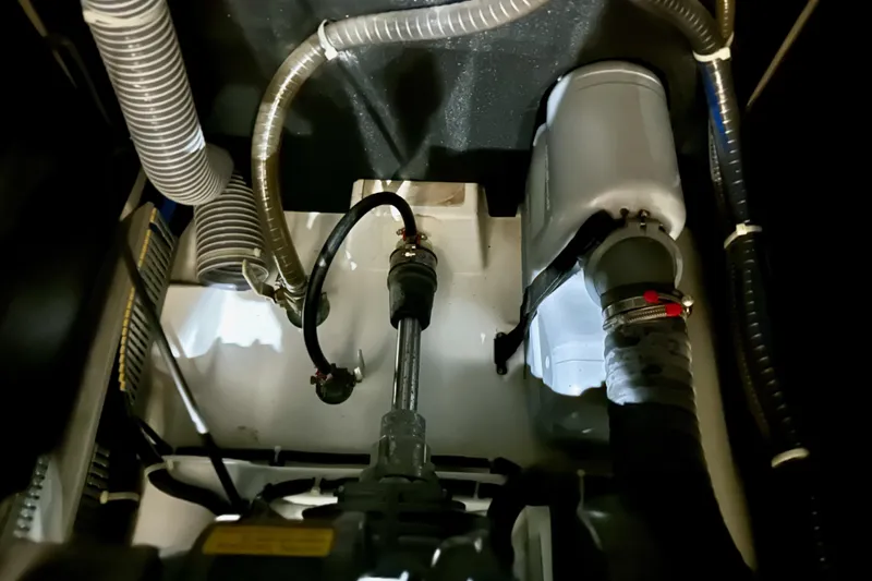Slide: The Image of Engine compartment of a 2021 Beneteau Oceanis 55.1 sailboat, showcasing hoses and components. - 84