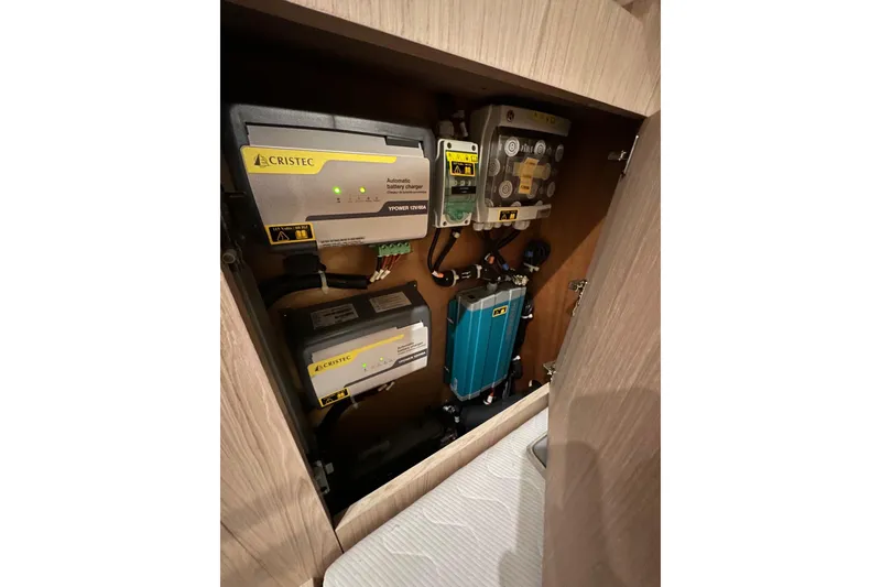 Slide: The Image of Electrical system components inside a 2021 Beneteau Oceanis 55.1 yacht cabinet. - 85