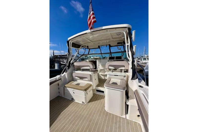 Slide: The Image of 2018 Wellcraft 290 Coastal boat interior with seating and American flag. - 13