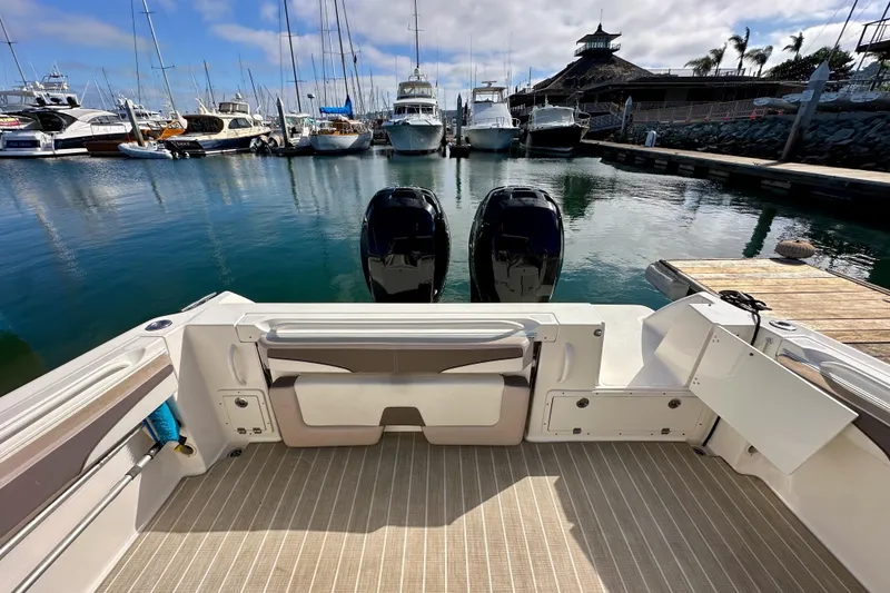 Slide: The Image of 2018 Wellcraft 290 Coastal boat docked at marina with twin engines. - 16