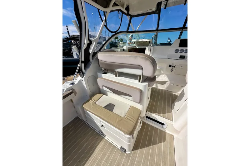 Slide: The Image of 2018 Wellcraft 290 Coastal boat interior with seating and dashboard, showcasing modern design. - 17
