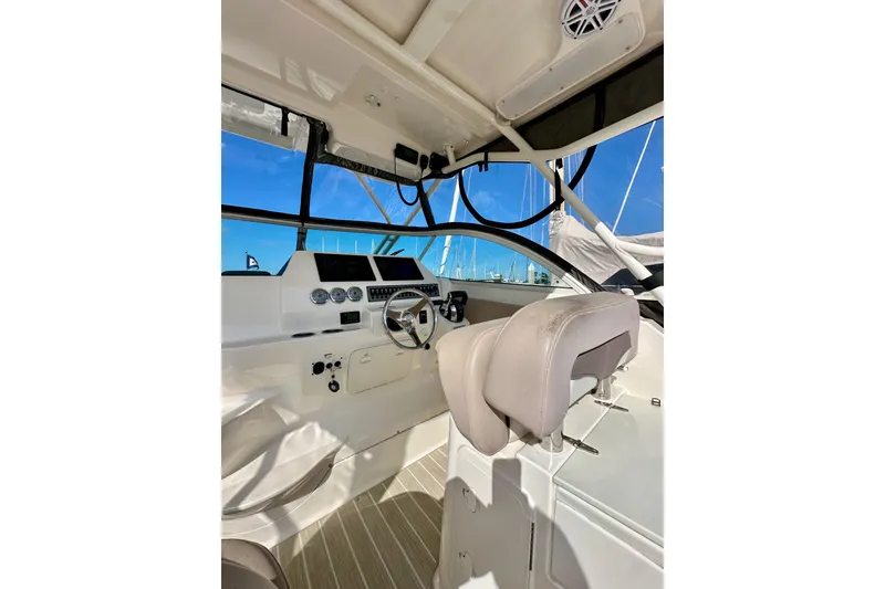 Slide: The Image of 2018 Wellcraft 290 Coastal boat cockpit with steering wheel and navigation instruments. - 19
