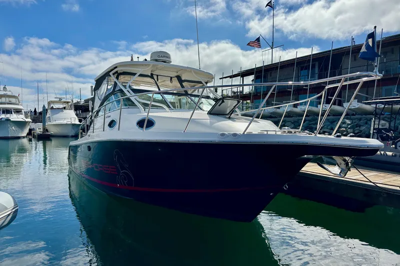 Slide: The Image of 2018 Wellcraft 290 Coastal boat docked at marina under blue sky. - 2