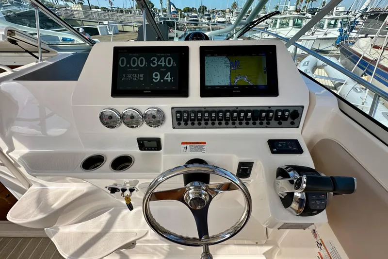Slide: The Image of 2018 Wellcraft 290 Coastal boat dashboard with navigation screens and controls. - 22