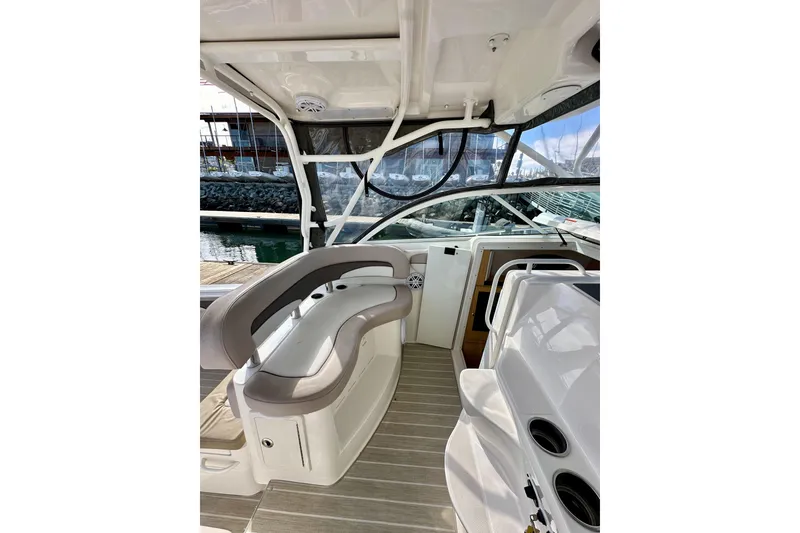 Slide: The Image of 2018 Wellcraft 290 Coastal boat interior with seating and helm, docked at marina. - 23