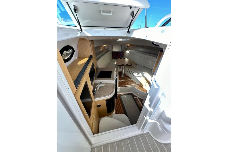 Slide: The Image of 2018 Wellcraft 290 Coastal cabin interior with kitchenette and seating area. - 26