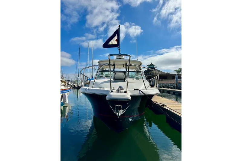 Slide: The Image of 2018 Wellcraft 290 Coastal boat docked in a marina under a clear blue sky. - 3