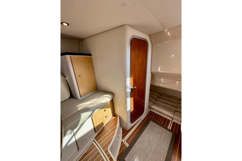 Slide: The Image of 2018 Wellcraft 290 Coastal cabin interior with wood accents and seating area. - 34