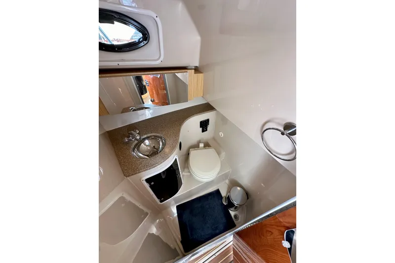 Slide: The Image of 2018 Wellcraft 290 Coastal boat bathroom with sink, toilet, and mirror. - 35