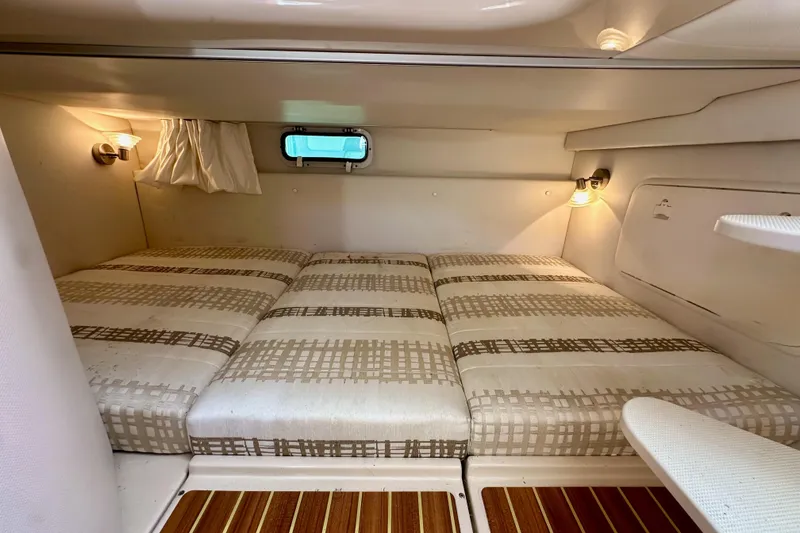 Slide: The Image of 2018 Wellcraft 290 Coastal cabin interior with cozy bed and ambient lighting. - 38