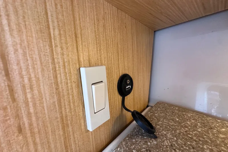 Slide: The Image of Light switch and USB port on Wellcraft 290 Coastal 2018 boat interior. - 39