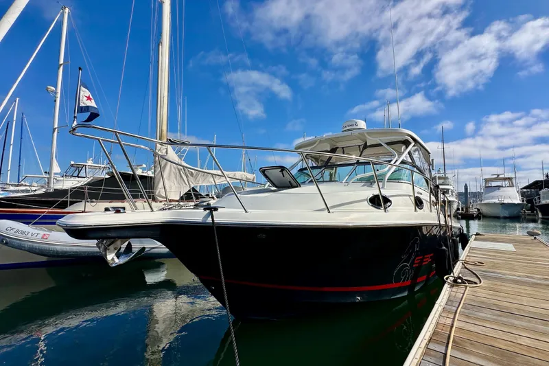 Slide: The Image of 2018 Wellcraft 290 Coastal boat docked at marina under blue sky. - 4