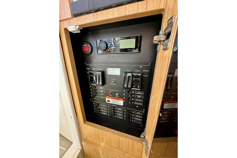 Slide: The Image of Electrical control panel inside 2018 Wellcraft 290 Coastal boat, featuring switches and displays. - 40