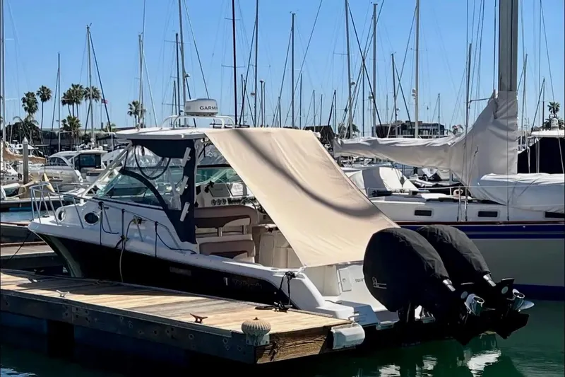 Slide: The Image of 2018 Wellcraft 290 Coastal boat docked at marina with covered outboard engines. - 42