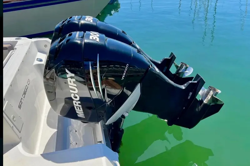 Slide: The Image of Twin Mercury outboard engines on a 2018 Wellcraft 290 Coastal boat in clear water. - 43