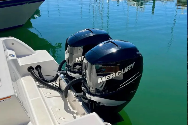 Slide: The Image of 2018 Wellcraft 290 Coastal boat with twin Mercury outboard engines on calm water. - 44