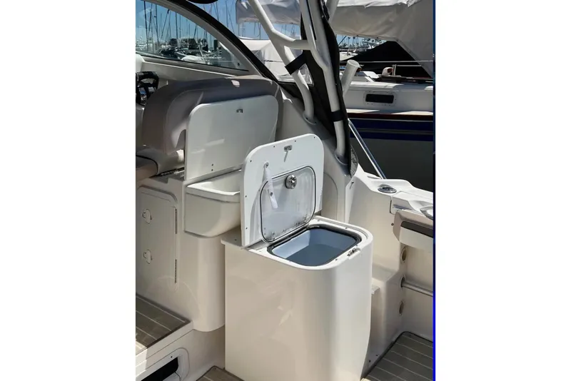 Slide: The Image of 2018 Wellcraft 290 Coastal boat interior with open storage compartment. - 48