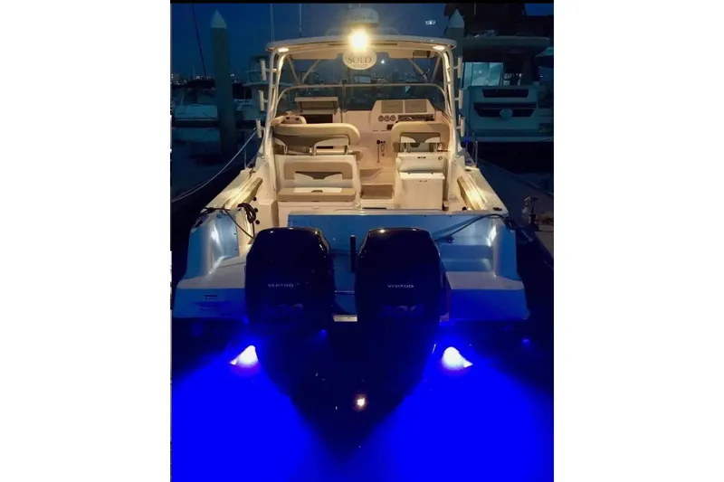 Slide: The Image of 2018 Wellcraft 290 Coastal boat with illuminated blue underwater lights at night. - 49