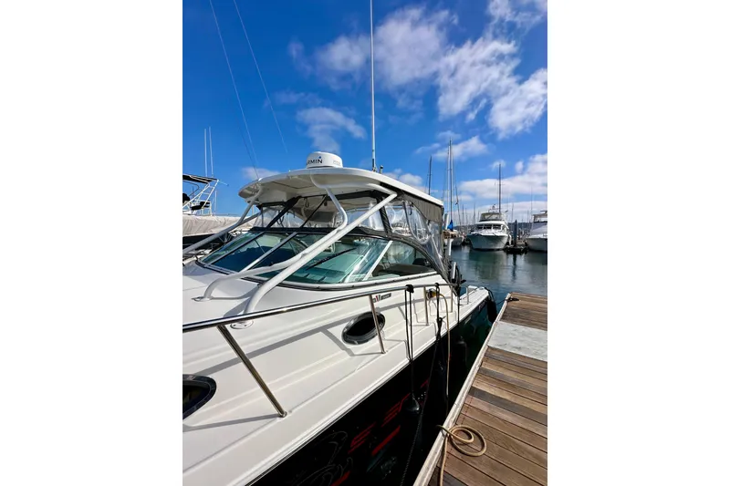 Slide: The Image of 2018 Wellcraft 290 Coastal boat docked at marina under blue sky. - 5