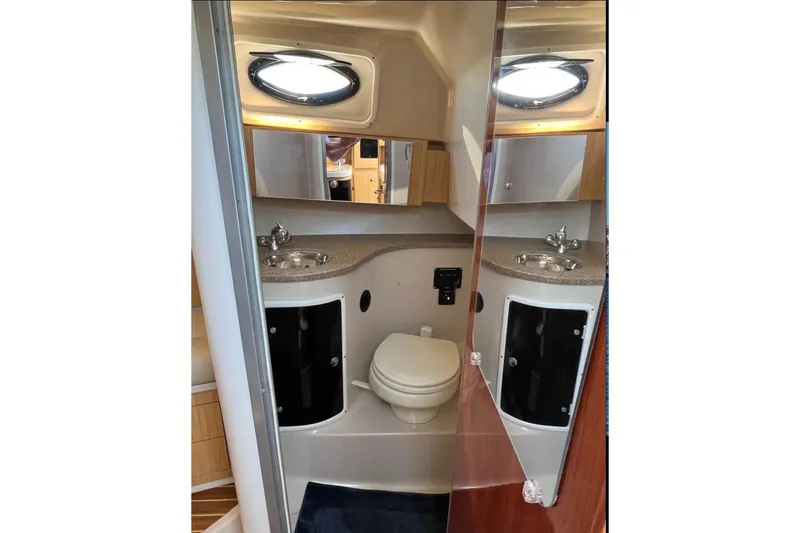 Slide: The Image of 2018 Wellcraft 290 Coastal boat bathroom with dual sinks and modern fixtures. - 50