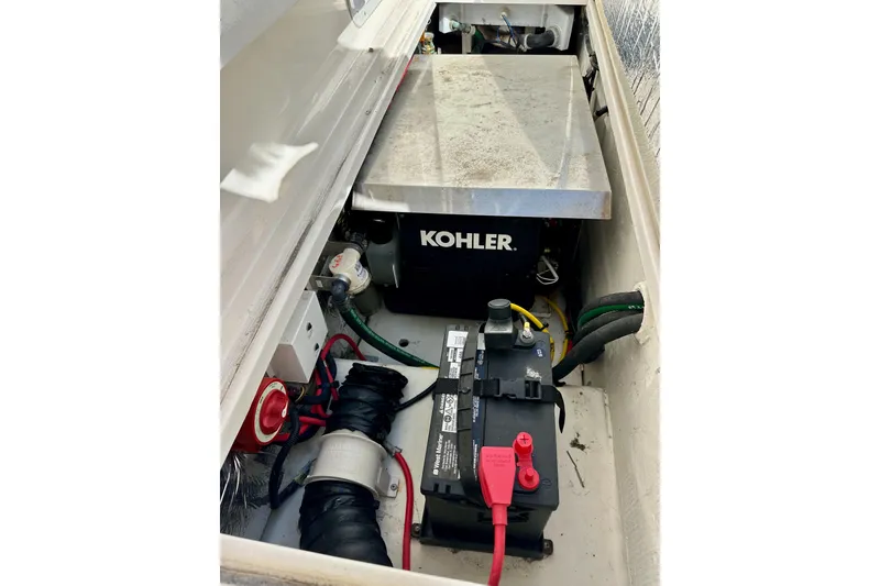 Slide: The Image of 2018 Wellcraft 290 Coastal engine compartment with Kohler generator and battery setup. - 54