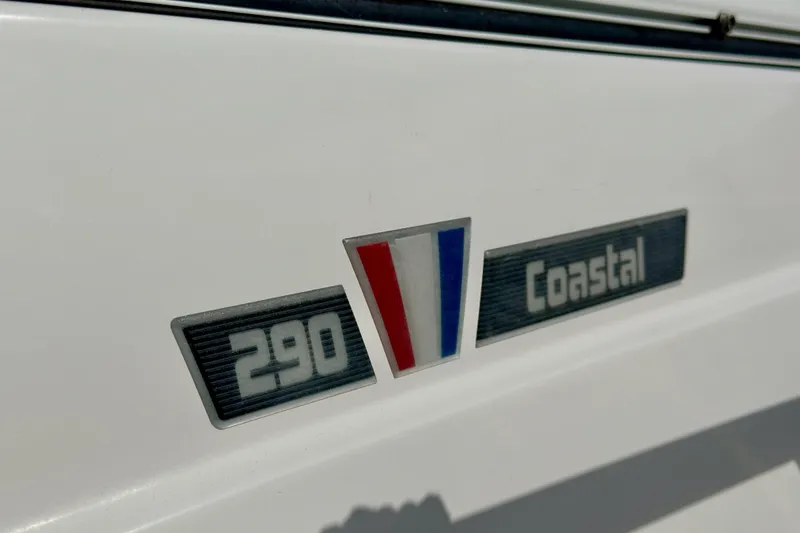 Slide: The Image of 2018 Wellcraft 290 Coastal boat emblem on white surface. - 6
