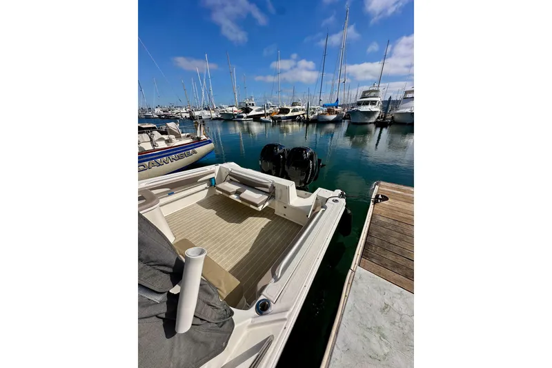 Slide: The Image of 2018 Wellcraft 290 Coastal boat docked in a marina with clear blue skies. - 7