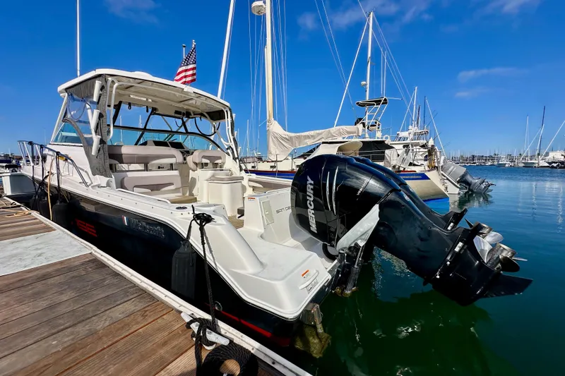 Slide: The Image of 2018 Wellcraft 290 Coastal boat docked with Mercury outboard engine. - 8