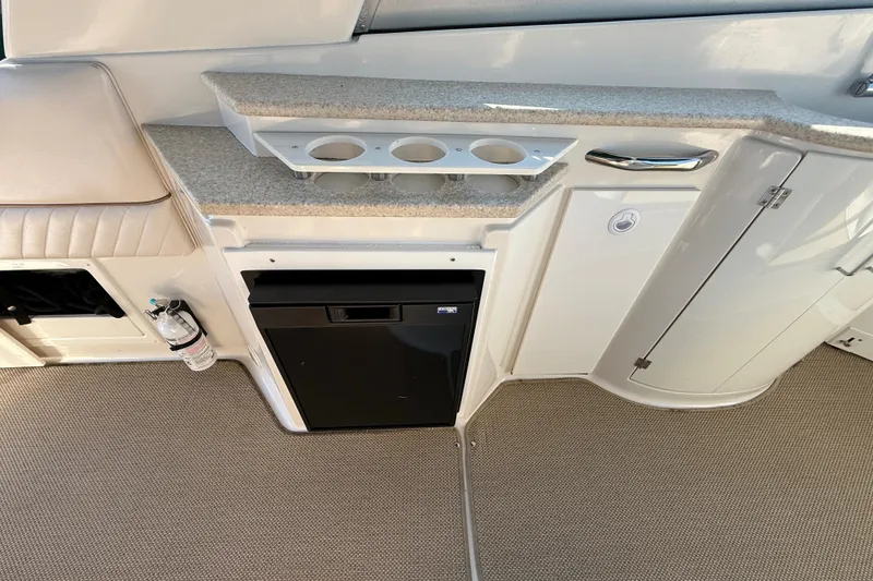 Slide: The Image of 2000 Monterey 322 Cruiser interior with kitchenette, storage, and fire extinguisher. - 11