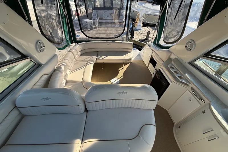 Slide: The Image of 2000 Monterey 322 Cruiser interior with white leather seating and kitchenette. - 15