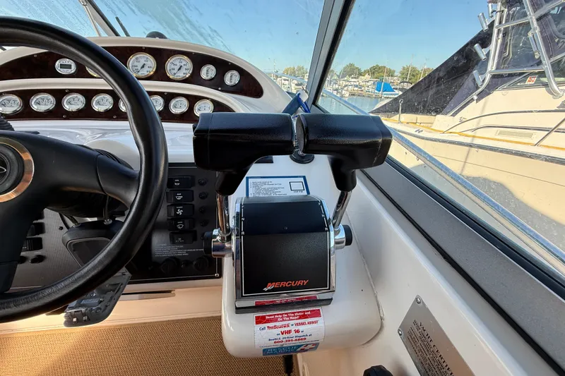 Slide: The Image of 2000 Monterey 322 Cruiser helm with Mercury controls and instrument panel. - 21