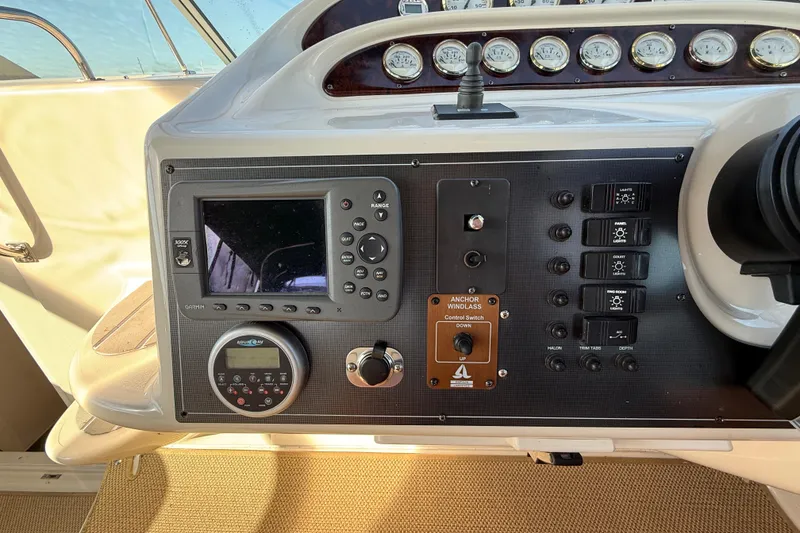 Slide: The Image of Control panel of a 2000 Monterey 322 Cruiser with navigation and switch controls. - 22